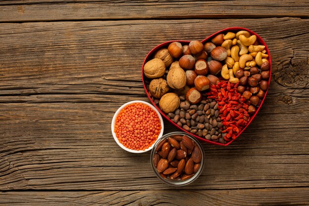 Box of nuts and spices on wooden table