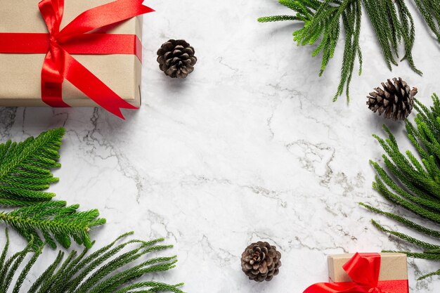 Box of present with Christmas ornament on marble background