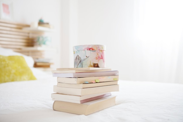 Box standing on bile of books