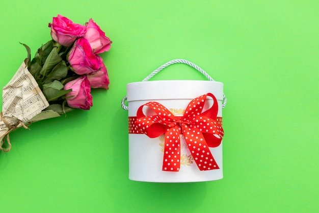 Box of sweets and bouquet of roses