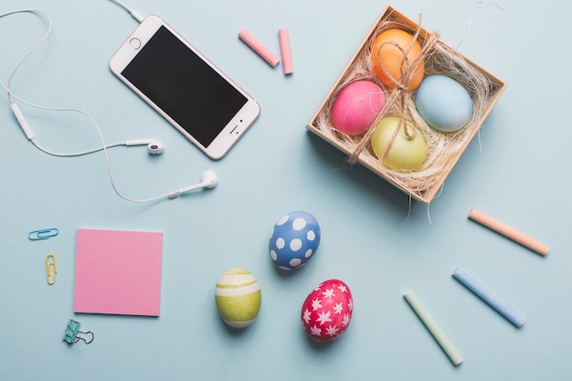 Box with eggs near smartphone