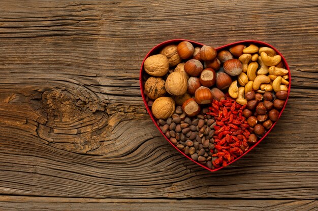 Box with nuts on wooden table