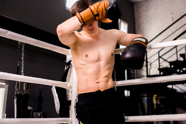 Free Photo boxer boy posing at the gym