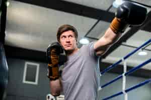 Free photo boxer boy posing at the gym