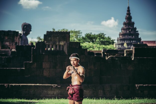 A boxer tied a rope in his hand and performed a fight, The martial arts of Muay Thai.