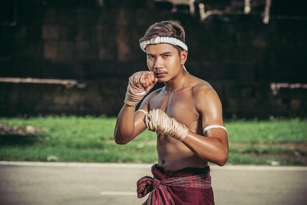 A boxer tied a rope in his hand and performed a fight, The martial arts of Muay Thai.