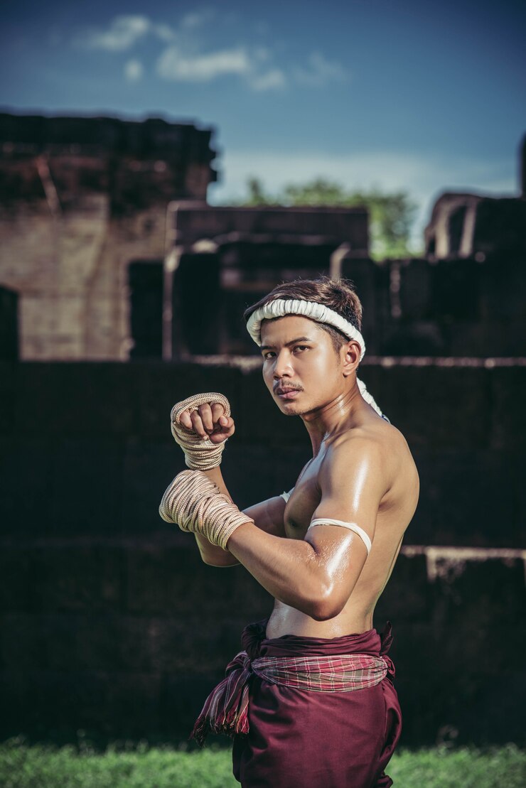 Free Photo a boxer tied a rope in his hand and performed a fight, the martial arts of muay thai.