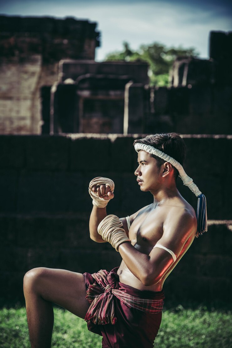 Free Photo a boxer tied a rope in his hand and performed a fight, the martial arts of muay thai.