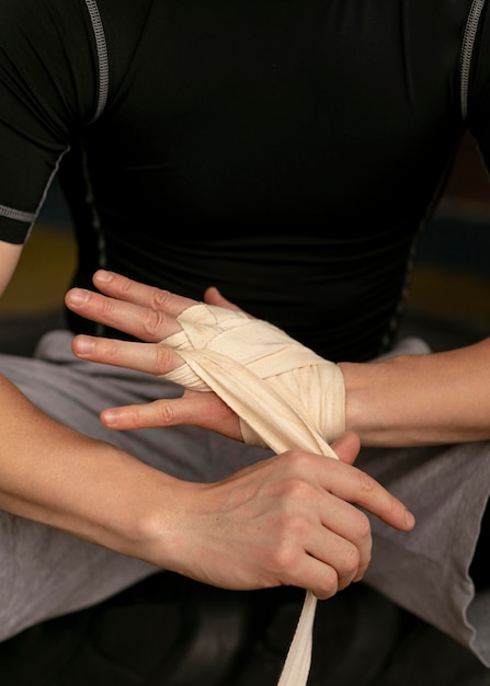 Boxer wrapping his hands with protection before exercising