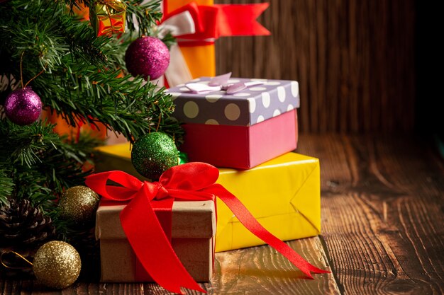 Boxes of present with Christmas ornament on wooden background