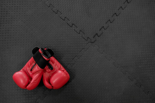 boxing gloves hang on nail on texture wall with copy space for text. Retirement concept