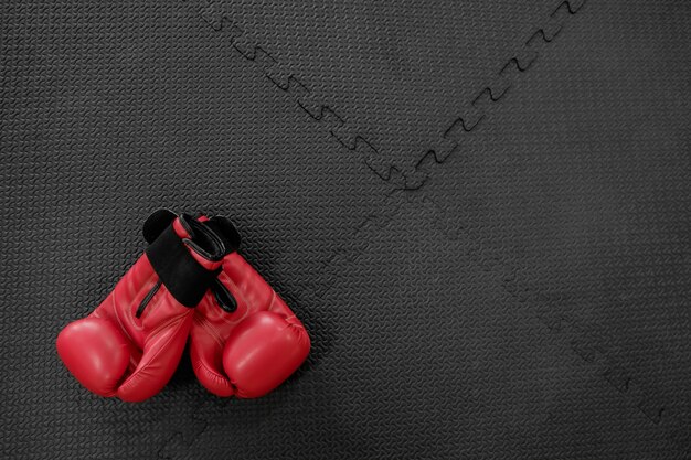 boxing gloves hang on nail on texture wall with copy space for text. Retirement concept