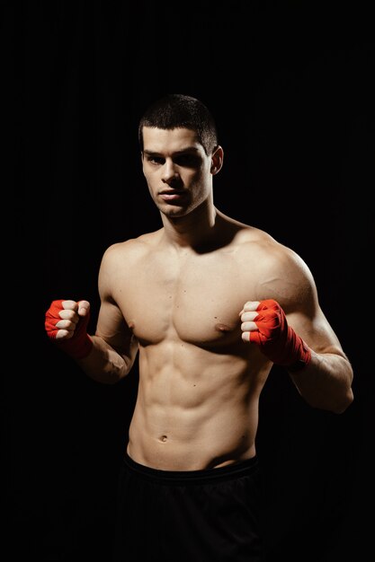 Boxing male portrait standing in a rack