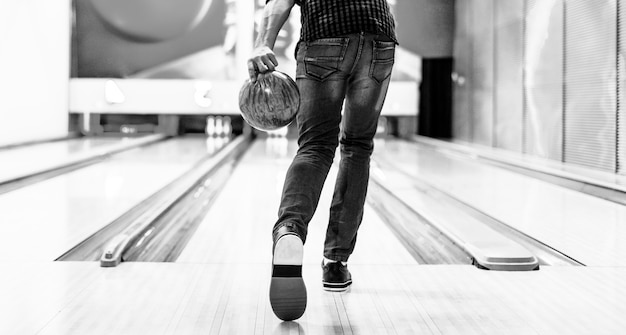 Free photo boy about to roll a bowling ball hobby and leisure concept