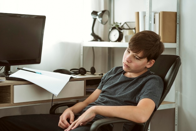 Free photo boy being bored about homework