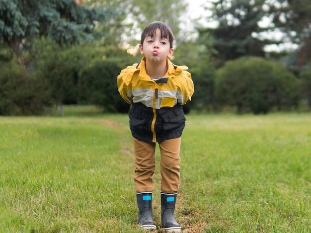 Boy blowing a kiss in the park