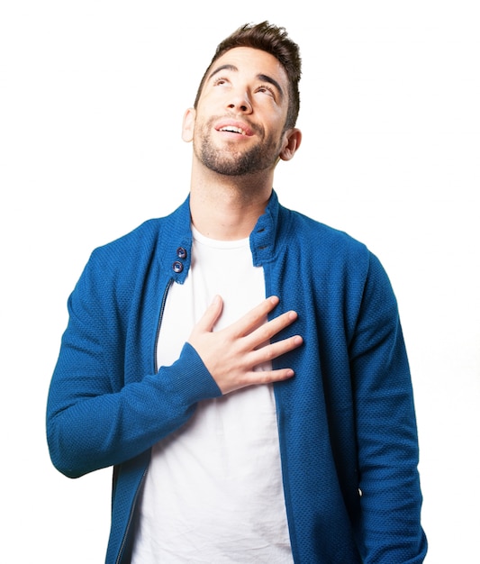 Boy in a blue jacket with his hand in his heart