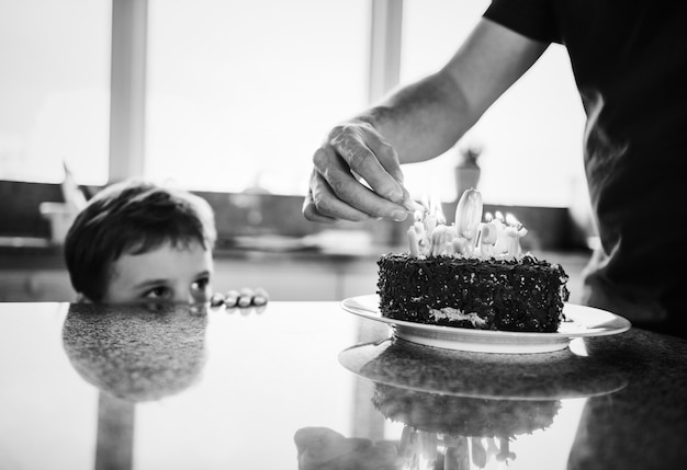 Free photo boy celebrating his birthday with a cake