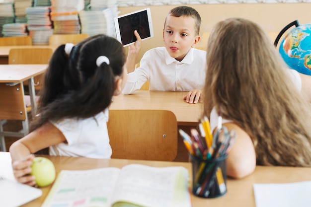 Boy communicating with girls in class