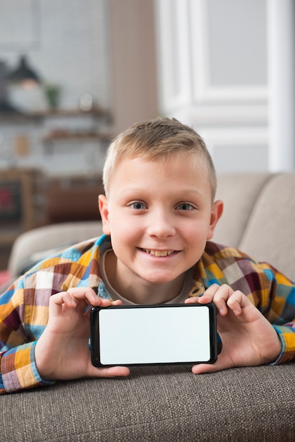 Boy on couch showing smartphone screen