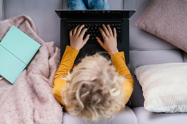 Boy on couch with laptop