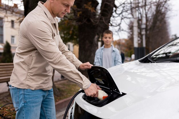 Boy and dad near an electric car