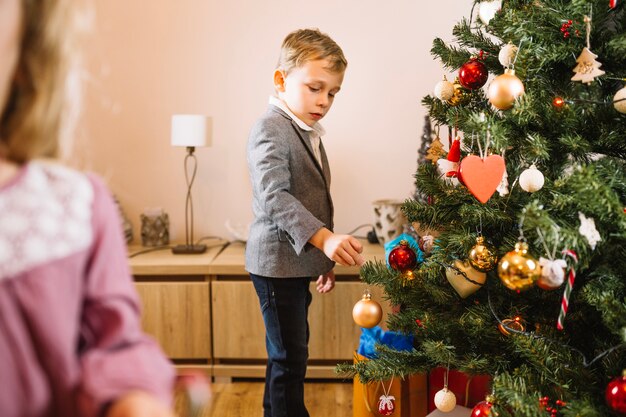 Boy decorating christmas tree