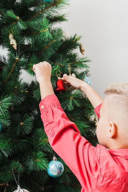 Boy decorating christmas tree