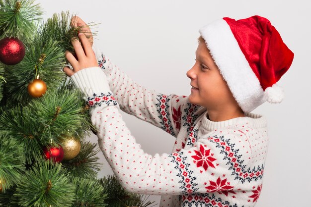 Boy decorating christmas tree