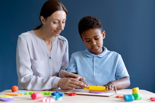 Boy doing a occupational therapy session with a psychologist