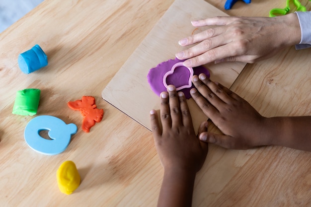 Boy doing a occupational therapy session with a psychologist