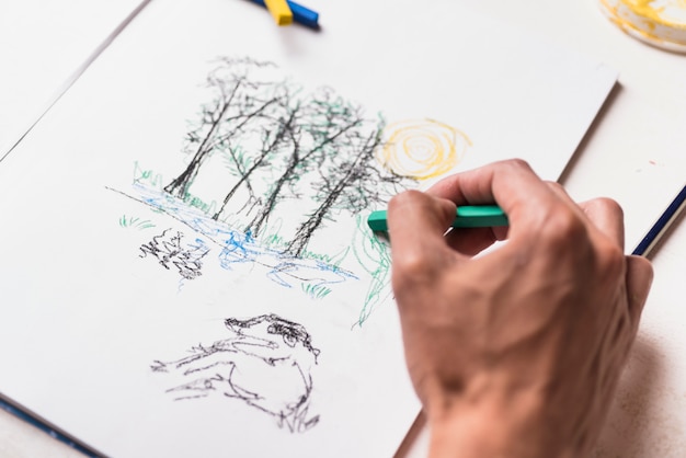 Boy drawing with crayon