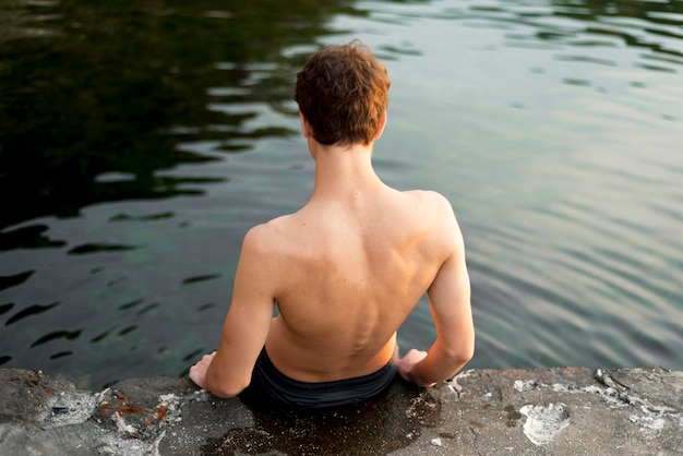 Free photo boy enjoying nature time in water