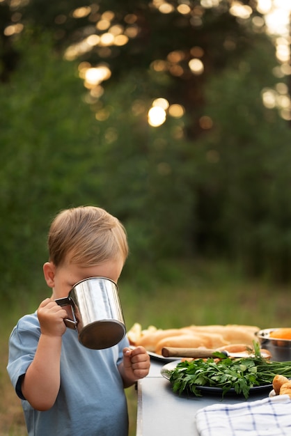 Free photo boy enjoying time in camping site