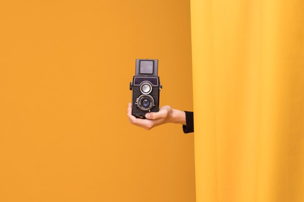 Boy filming with a camcorder in a yellow scene