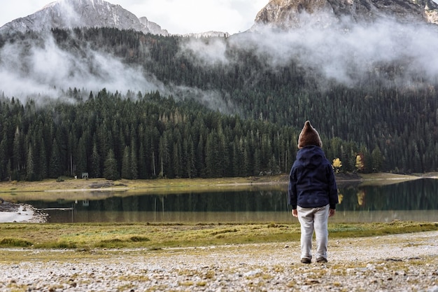 Boy in a funny hat looking at Black Lake Durmitor National Park Zabljak Montenegro