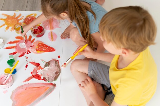 Boy and girl painting together close up