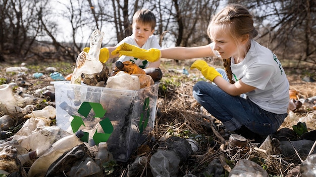 Boy and girl at plastic garbage collection