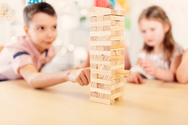 boy and girl playing wooden game