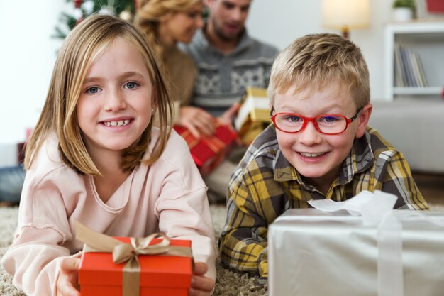 Boy and girl with a red gift and a silver gift