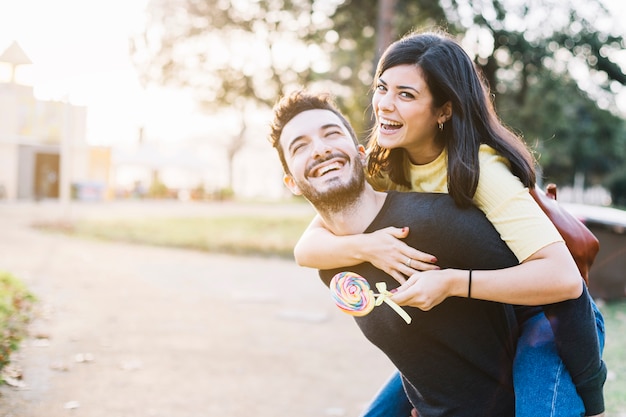 Boy giving a piggy back ride to his girlfriend