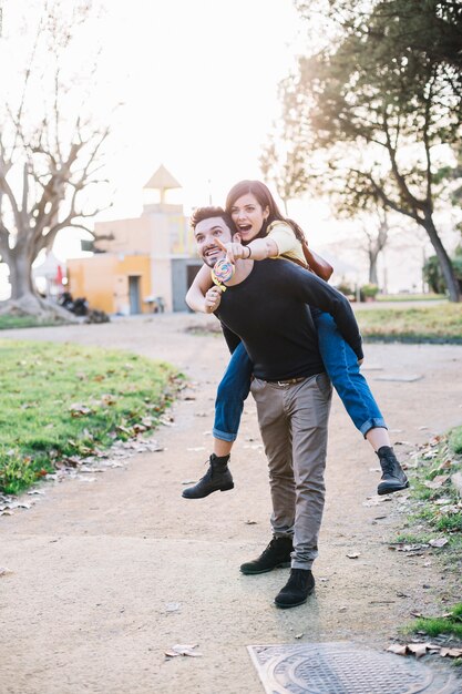 Boy giving a piggy back ride to his girlfriend