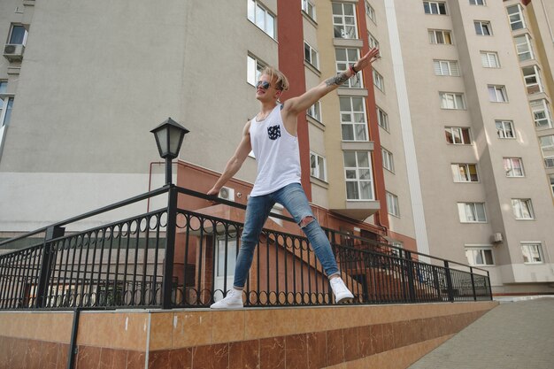 Boy hanging in the air on the buildings scene