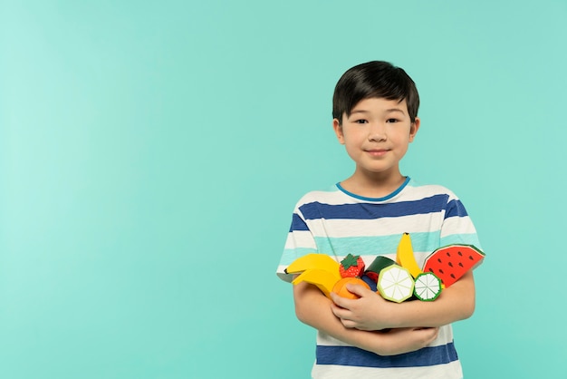 Boy having fun in a blue summer setting studio