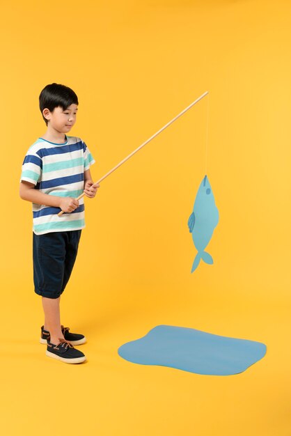 Boy having fun in a summer setting studio