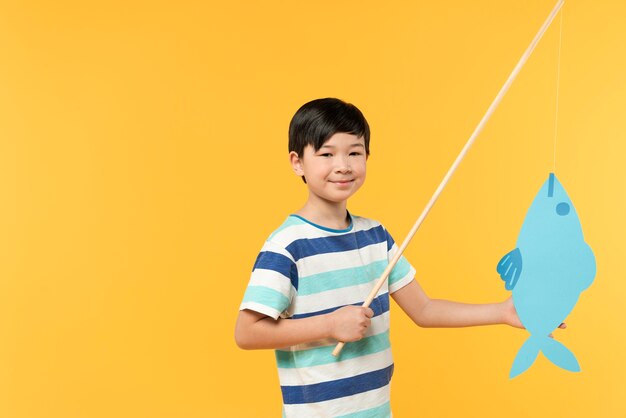 Boy having fun in a summer setting studio