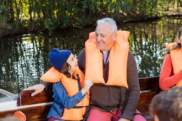 Free photo boy having fun with his grandfather on the boat