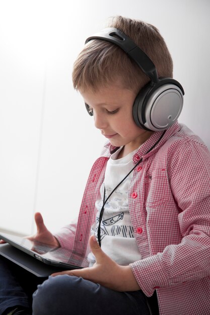 Boy in headphones using tablet