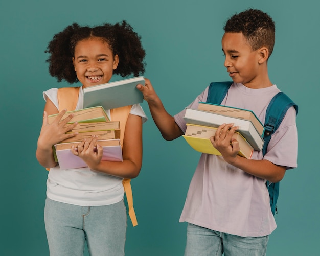 Boy helping his friend with the books