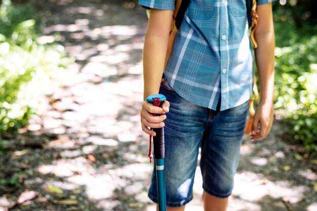 Boy hiking through a forest